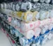 Close-up of fabric rolls in various colors and textures, displaying a wide selection of premium textiles for fashion and design.